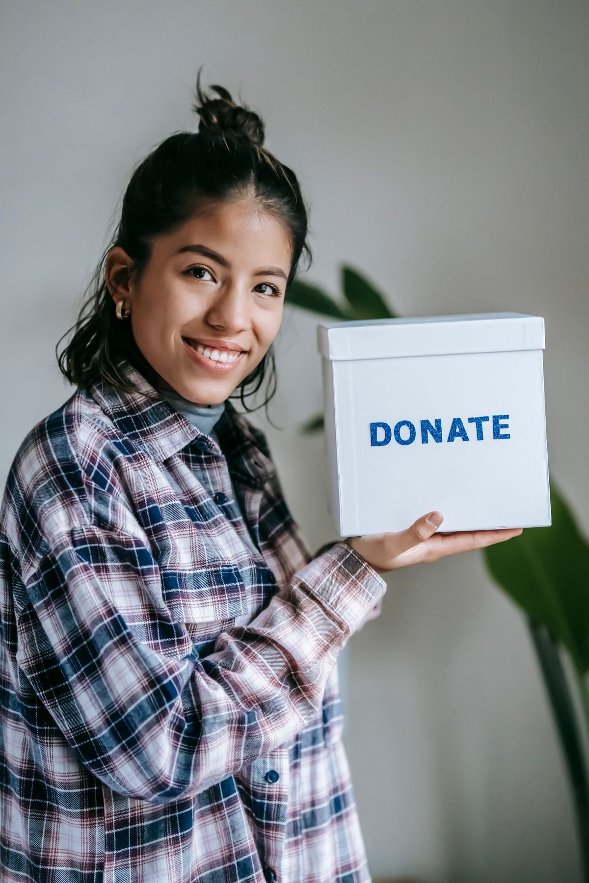 A volunteer holding a donation box
