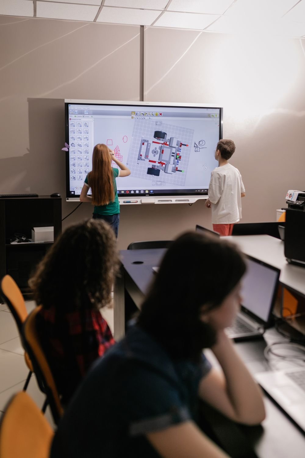 Children learning with an interactive board