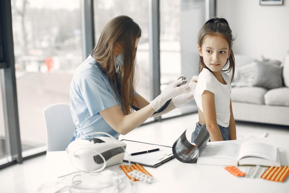 A young girl receiving a check-up at a clinic