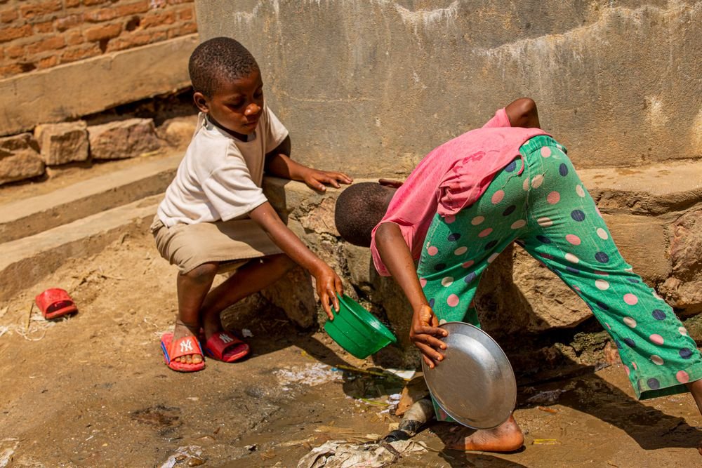 Two young boys next to a well